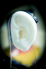 Plastic ear with modern hearing aid