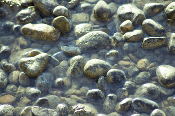 Fototapeta na wymiar Set of natural stones on the bank of a river