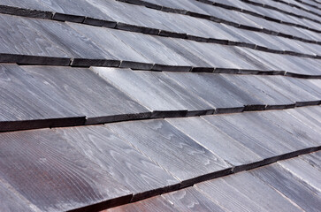 Shingled house roof with rows at an angle