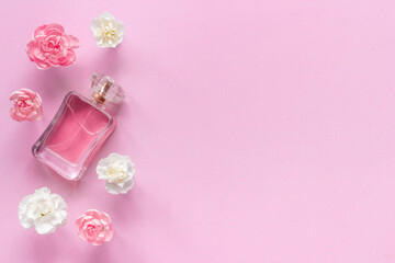 Fototapeta na wymiar Floral flat lay with perfume bottle, top view