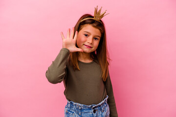 Little princess girl with crown isolated on pink background smiling cheerful showing number five...