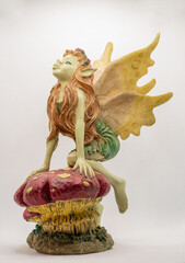 figure of a winged fairy perched on a mushroom