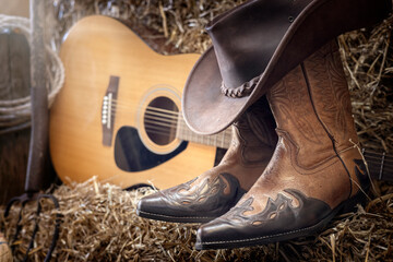 Country music festival live concert or rodeo with cowboy hat guitar and boots in barn - obrazy, fototapety, plakaty