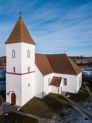 Fototapeta na wymiar Aerial view of Alsunga catholic chursh in winter, Latvia. 