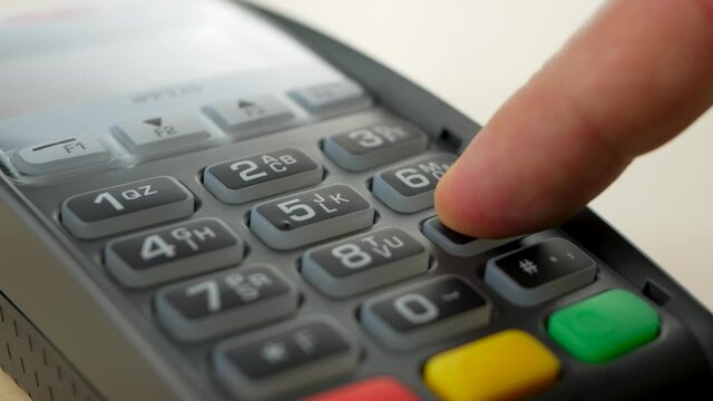 Customer pay by contactless credit card with NFC technology. Credit card reader machine. Enter PIN code. Pay with mobile wallet. Wireless modern bank payment terminal after coronavirus quarantine