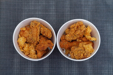 Fast food Breaded chicken nuggets in a paper cup on the table
