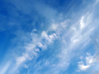 Naklejka na ściany i meble Blue sky with fluffy white clouds, can be used as background for your artwork