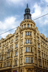 yellow corner building representing architecture of prague 