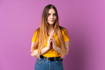 Young caucasian woman isolated on purple background scheming something