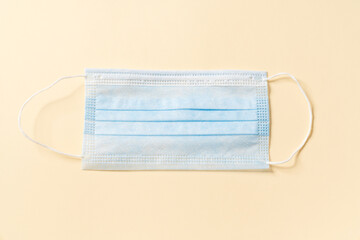 A disposable protective mask to prevent coronavirus disease lying in the studio