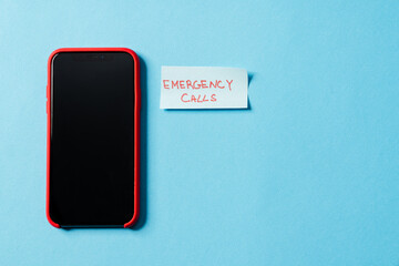 Overhead view of the phone with the turning screen to the camera, lying with a piece of paper...