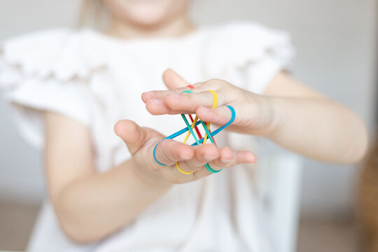 Hand strengthening exercise for kids , adults, seniors. Child using rubbers for stronger hands.