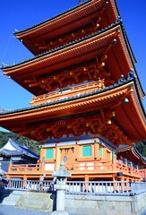Naklejka premium The Buddhist temple of Kiyumizudera stands on the waters of the Otowa waterfall, in spring surrounded by cherry and maple trees in bloom. Its name means Pure Water Temple.