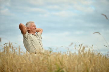Mature man enjoying fresh air at wheat field