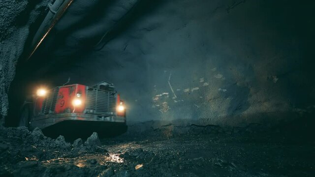Minery tunnel with industrial machinery moving through it