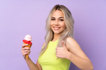Teenager girl over isolated purple background with thumbs up because something good has happened