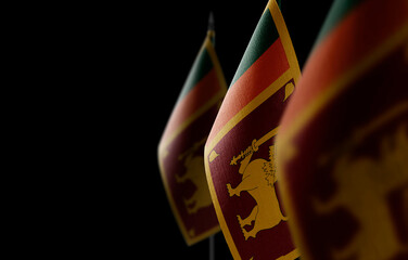 Small national flags of the Sri Lanka on a black background