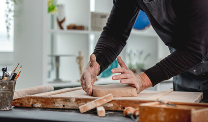 Man working with clay at pottery workshop