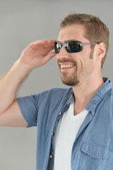 Portrait of  handsome young man posing in sunglasses