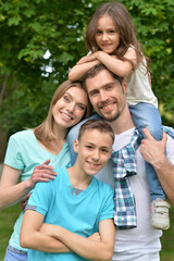 Fototapeta premium Portrait of happy young family in summer park