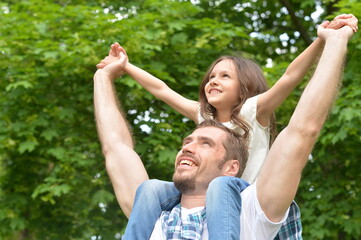 Portrait of father and daughter having fun outdoors