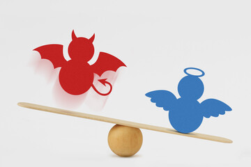 Devil and angel on balance scale - Victory of good over evil concept