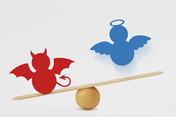 Devil and angel on balance scale - Predominance of evil over good concept