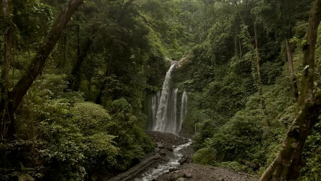 Aerial view one of the most beautiful waterfall Air Terjun Tiu Kelep waterfall near Rinjani, Senaru, Lombok, Indonesia, Southeast Asia. Tropical forest. Layered water flows, green scenery. 4k footage