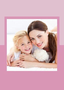 Portrait Of Mother And Daughter Smiling Against Dual Tone Pink Background Frame