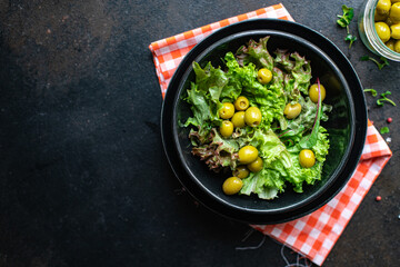 salad olives leaves green petals lettuce mix fresh healthy appetizer trend diet meal snack copy space food background rustic. top view keto or paleo diet vegan or vegetarian food
