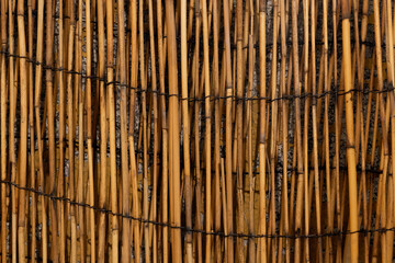 old house concrete wall covered with a straw blanket