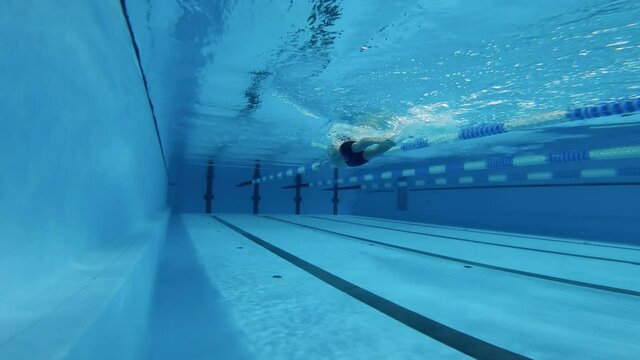 Professional male athlete swimming underwater