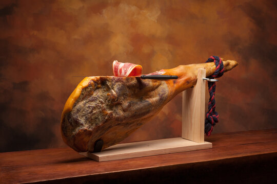 Hamon - leg of dried pork meat - on a wooden stand.