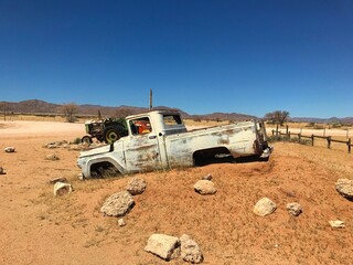 Old car wreck at Solitaire petrol station in the middle of nowhere in Namib Desert in Namibia