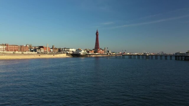 4K: Aerial Drone Video of The Blackpool Tower, England, UK. Flying low over the sea towards the pier. Stock Video Clip Footage