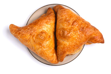 Samsa - Eastern food. Two pieces are on a plate. Isolated on white background. Top view. Close up.