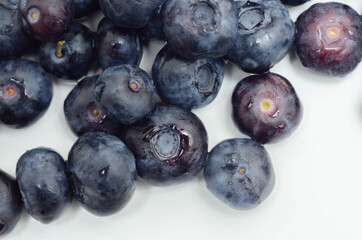 Closeup on fresh and ripe blueberries on a white background
