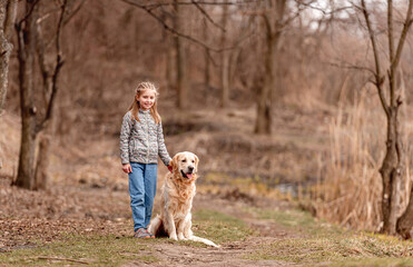 Preteen girl with golden retriever dog