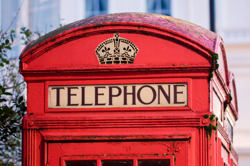 Vintage red telephone box close-up. Word telephone from London UK