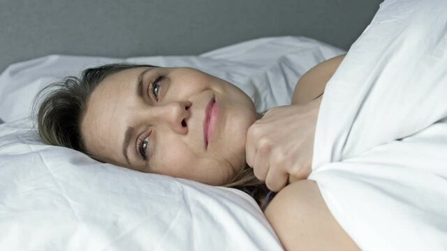 Beautiful woman falls asleep with a happy smile on her face.