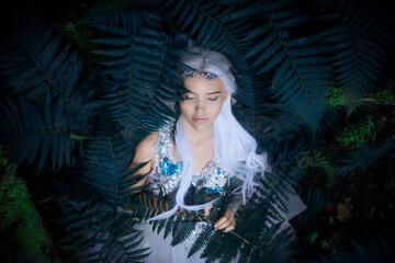 Portrait of a sleeping mysterious Elf princess in summer forest © Elvenphoto