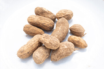 Fototapeta na wymiar A Pile of Raw Peanuts with soil isolated on white background.