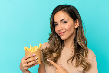 Young woman holding fried chips over isolated background