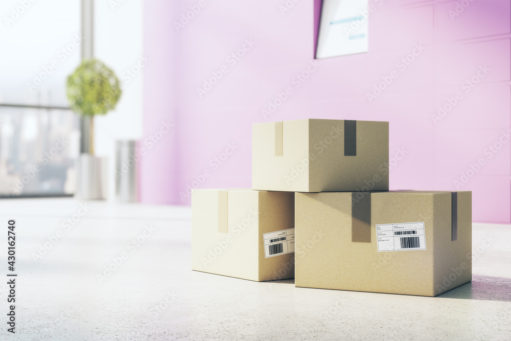 Poster delivery and courier service concept with cardboxes with barcodes on concrete floor in empty sunny r