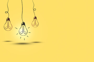 illustration of hanging glowing light bulb on yellow background and copy space.