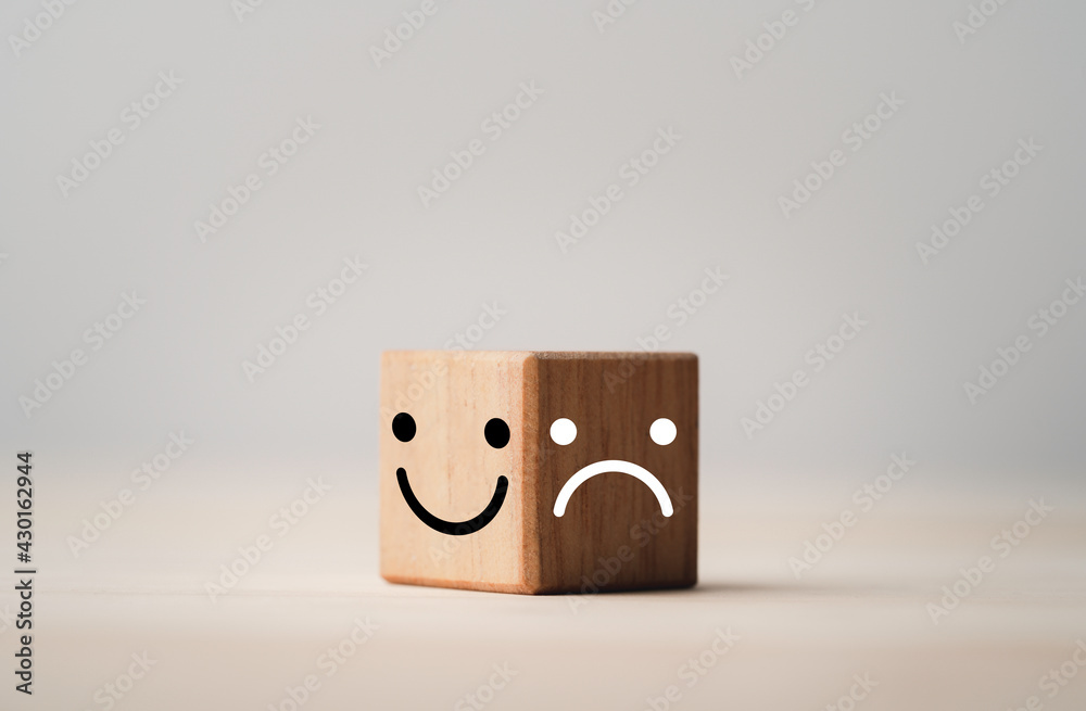 Poster Smiley face on bright side and sadness on dark side of wooden cube block , Emotion selection and mindset concept.