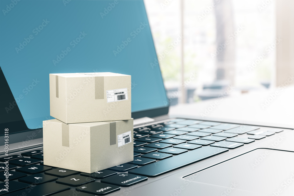 Poster online shopping and delivery concept with cardboard boxes on laptop keyboard