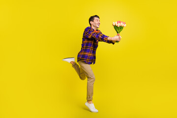 Photo of guy stand tiptoe hold bunch flowers wear bow tie plaid shirt pants footwear isolated...