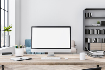 Blank white computer monitor on light wooden table on stylish home workspace with white wall and big window. 3D rendering, mockup