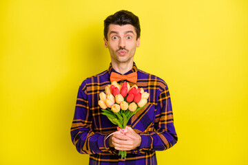 Photo of guy hold bunch flowers send air kiss wear bow tie plaid shirt isolated yellow color background